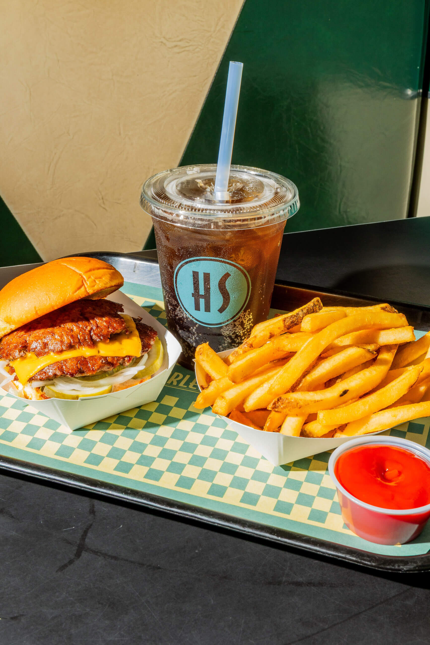 burger, fries, and a cold soda with kechup on the side